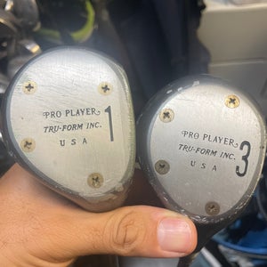 Pro player vintage driver and 3 wood in right hand