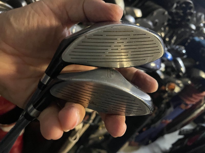 Zero tolerance golf driver and 7 wood in right Hand