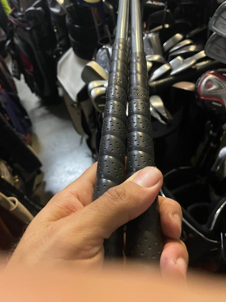 Zero tolerance golf driver and 7 wood in right Hand