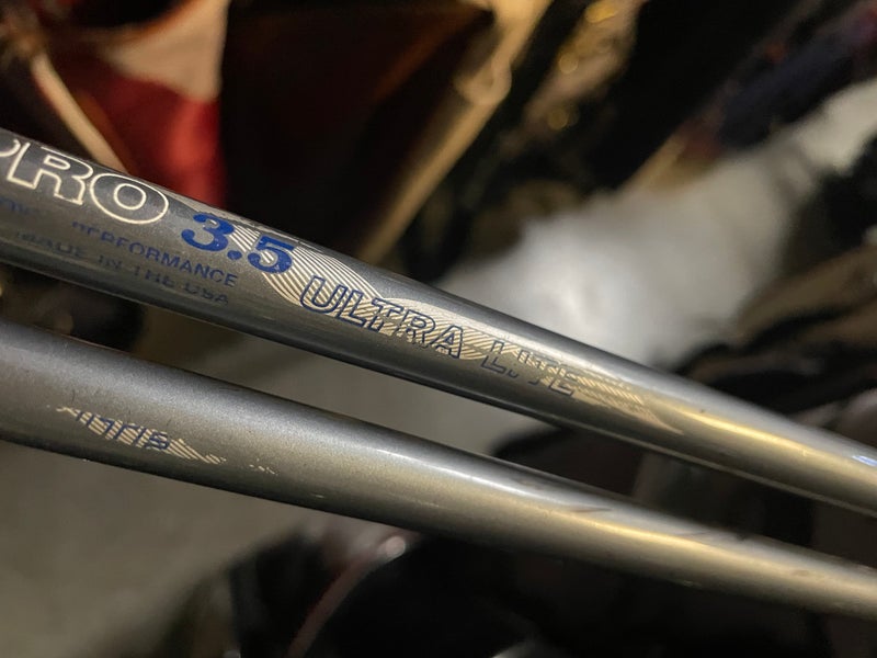 Zero tolerance golf driver and 7 wood in right Hand