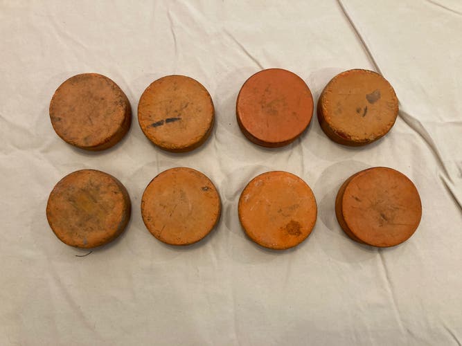 8 weighted orange hockey pucks