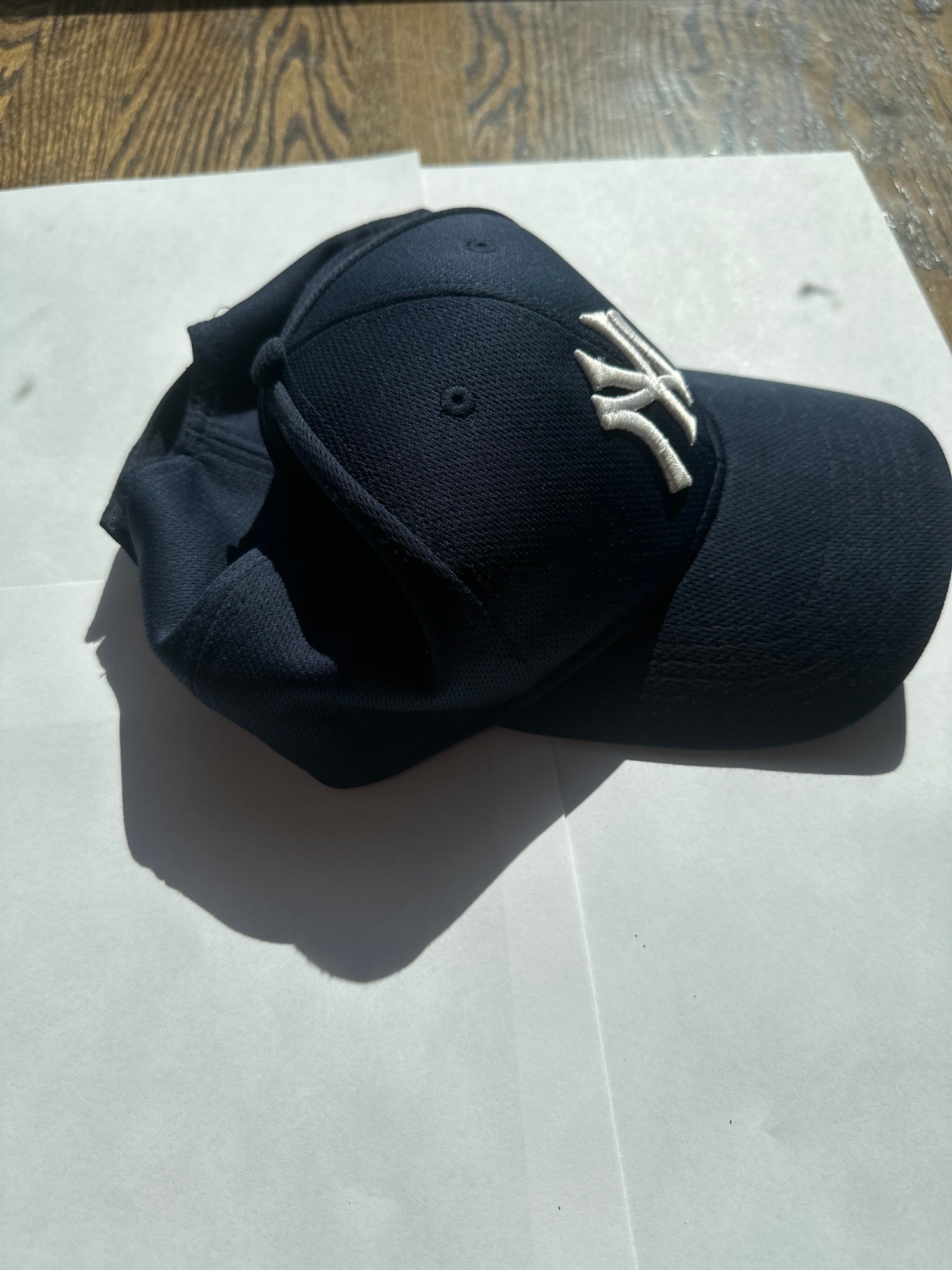 Navy blue Yankees hat, Velcro latched in the back