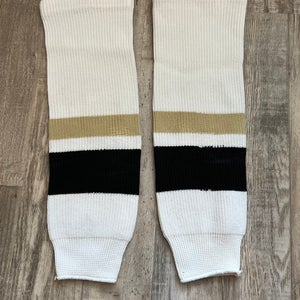 White/black/gold Used Hockey Shin Pad Socks 19”. A R1 S4 L1