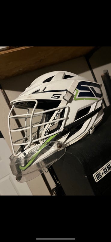 White lacrosse cascade s helmet with goalie throat guard