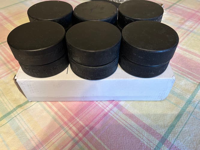 12 Used Hockey Pucks