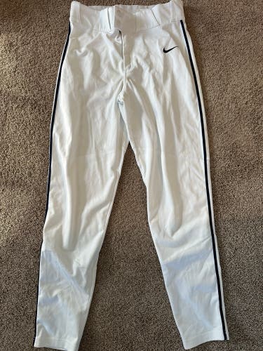 Nike full length white baseball pants with navy piping.