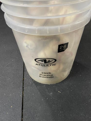 50 used baseballs in a bucket