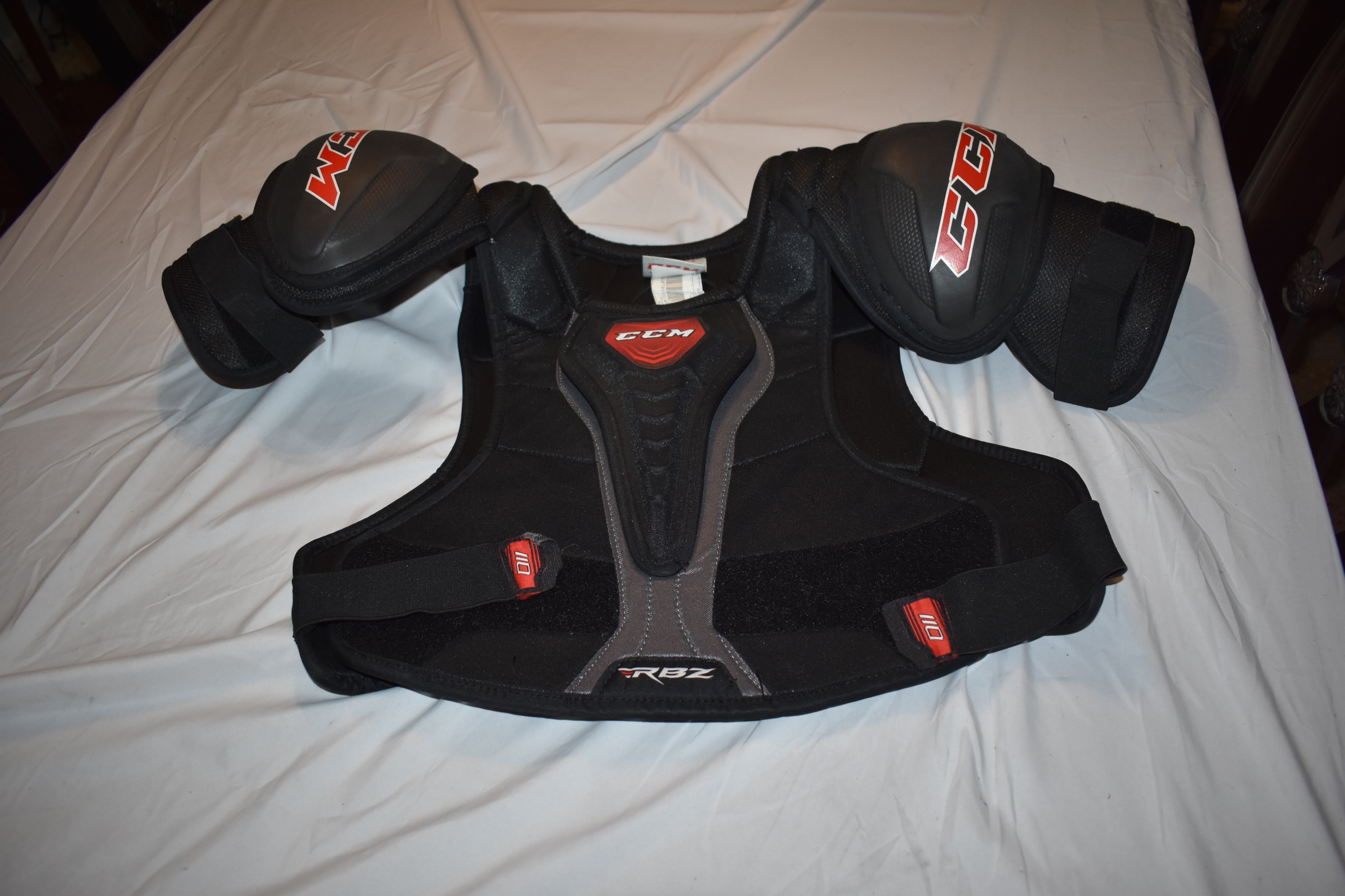 CCM RBZ110 Hockey Shoulder Pads, Black/Red, Senior XL
