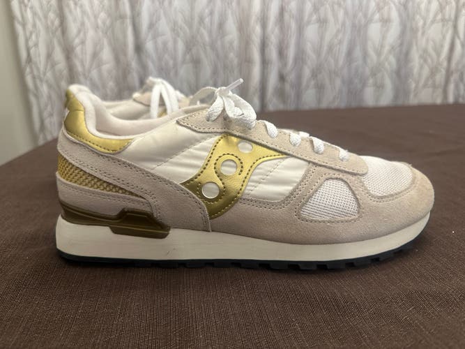 Saucony shadow original gold and white athletic shoes.