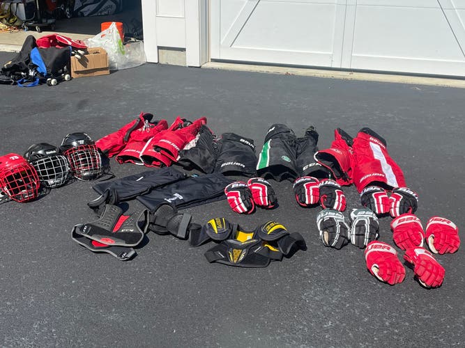 5 hockey pants. 3 helmets. 6 gloves. 2 shoulder pads. All junior protective gear.