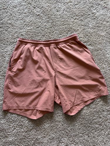 Orange Lululemon pace breaker shorts 7” inseam