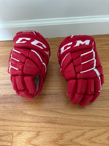 Red CCM hockey gloves