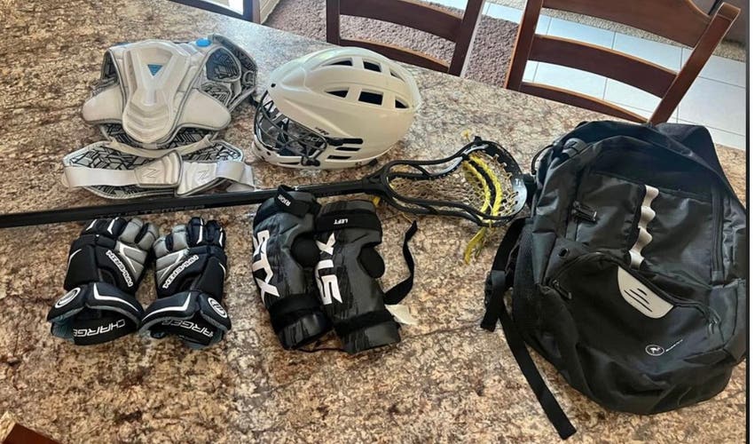 Boys lacrosse gear includes stick, helmet, bag, and all padding.