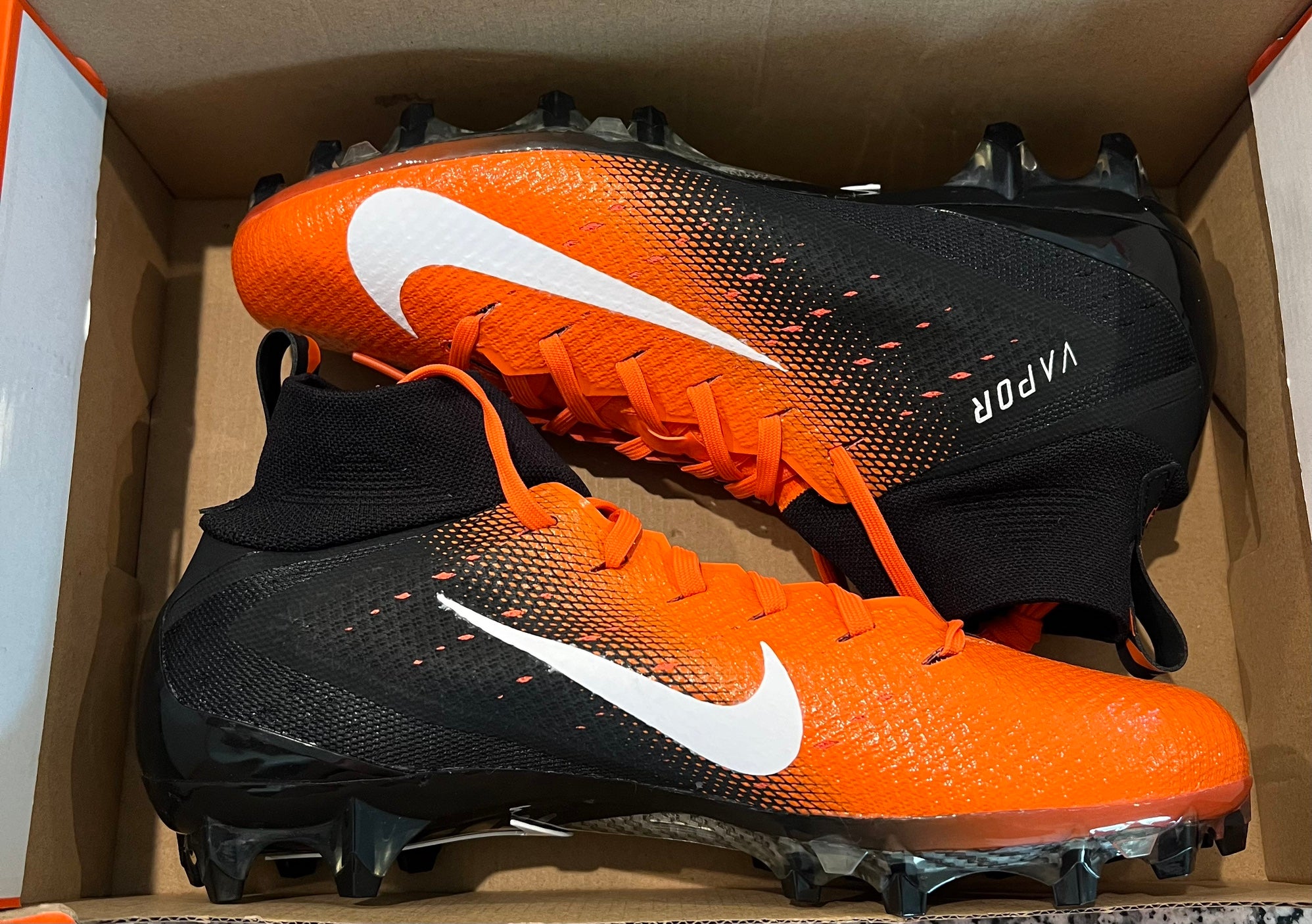 orange and black football cleats