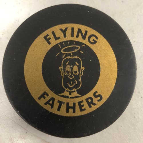 Flying Fathers puck (Playing & Praying)