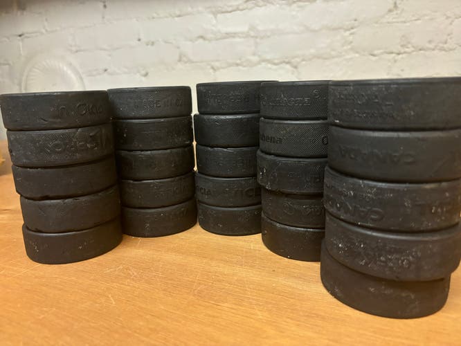 25 Used Hockey Pucks