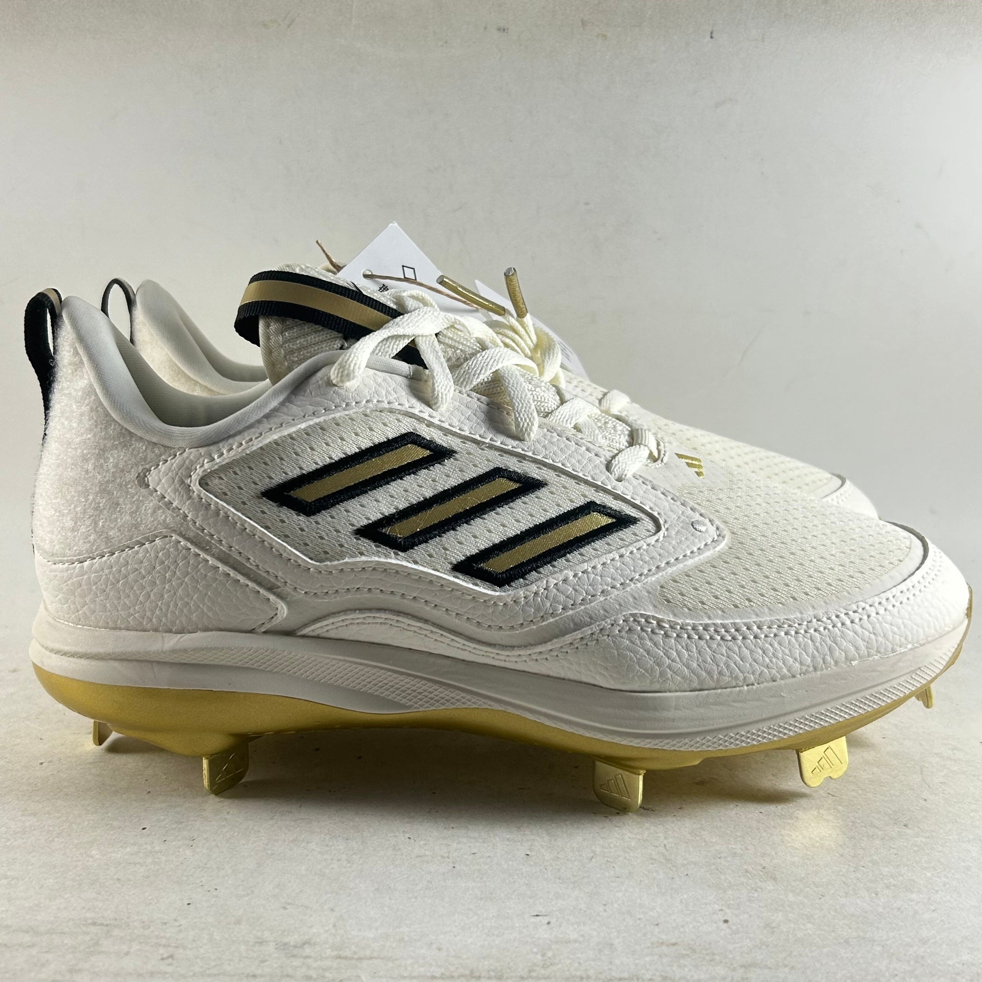 gold and white softball cleats