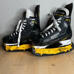 Used Intermediate Bauer Supreme M1 Hockey Skates Regular Width Size 5.5 With Yellow Skate Guards