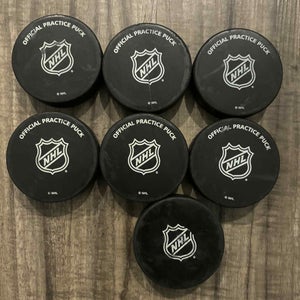 Lot of 7 NHL Official Practice Hockey Pucks