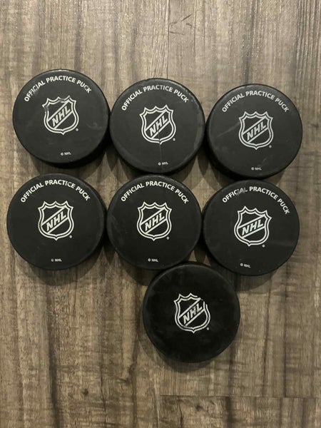 Lot of 7 NHL Official Practice Hockey Pucks