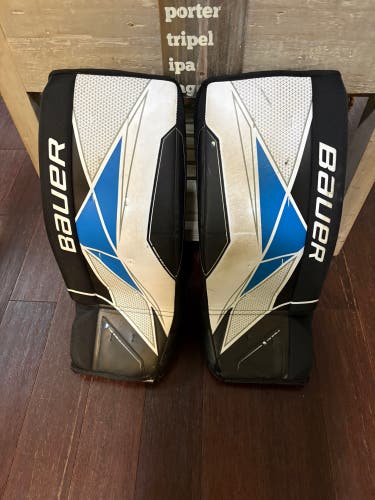 White, black, and blue 27" Junior Bauer Goalie Leg Pads