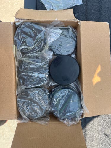 Box of 11 brand new hockey pucks