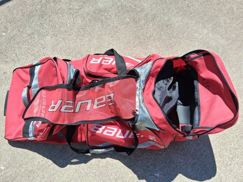 Red Bauer hockey equipment Bag with wheels 40*16*16 (Used)
