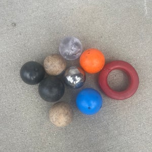 Assortment of hockey stickhandling balls and a stick weight