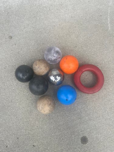 Assortment of hockey stickhandling balls and a stick weight