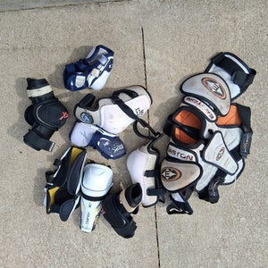Bundle of 8 various junior hockey items: elbow pads, shoulder pads, shin pads