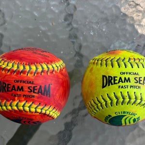 (Used) 2 Rawlings Dream Seam 1/2 red colored 11” softballs - used for pitching
