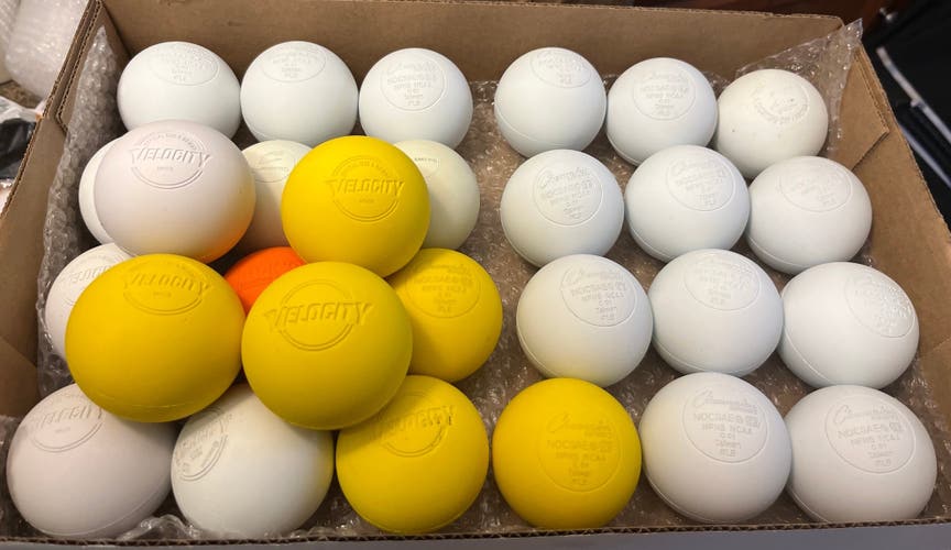 32 new and lightly used lacrosse balls, mostly champion, Velocity, and a couple assorted NOCSAE