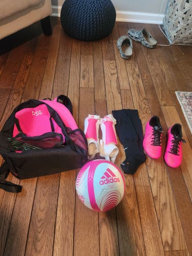 Girls Soccer stuff. 1 bag, 1 pair of cletes, 1 pair of socks, 1 pair of shin guards, 1 Soccer ball