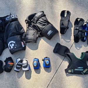 Bundle of 8 junior various hockey items: pants, elbow pads, shin guards, shoulder pads (USED)