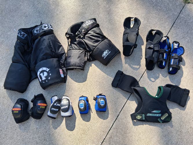 Bundle of 8 junior various hockey items: pants, elbow pads, shin guards, shoulder pads (USED)