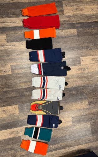12 pairs of hockey socks (some brand new some used) size from  24” to 16”)
