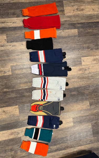 12 pairs of hockey socks (some brand new some used) size from  24” to 16”)