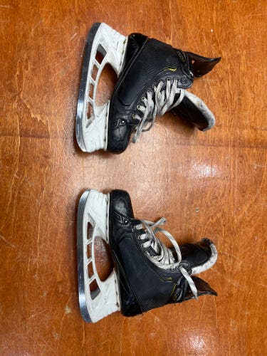 Used Senior Bauer Supreme UltraSonic Hockey Skates Regular Width Pro Stock 8.5 with shot blockers.
