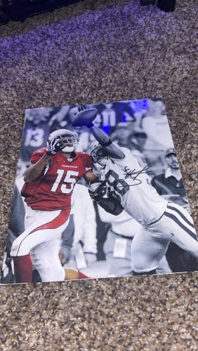 The image is an autographed photo of former Arizona Cardinals players Kurt Warner and Jamell Fleming