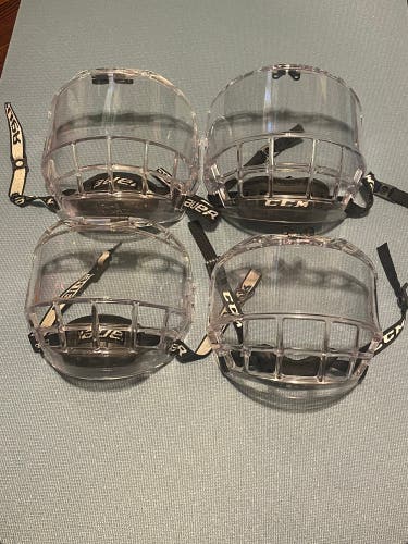 Used ice hockey helmet face shields. Listing is for only one of the four shown