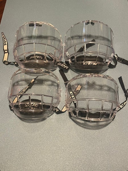 Used ice hockey helmet face shields. Listing is for only one of the four shown