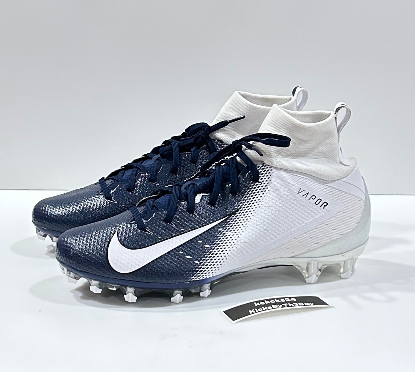 navy blue and white nike cleats