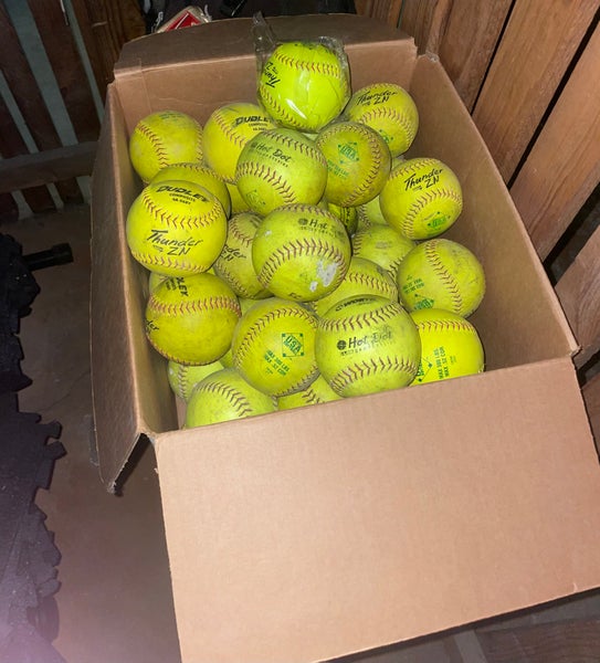 Box of 47 used softballs
