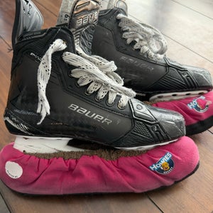 Black 2024 Bauer Supreme Shadow Hockey Skates with black steel blades