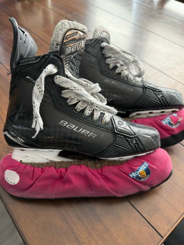 Black 2024 Bauer Supreme Shadow Hockey Skates with black steel blades