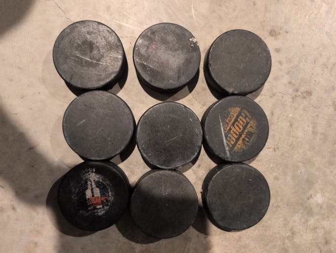 9 hockey pucks (used)