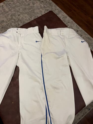 White Men's Medium Adult Nike Game Pants with blue pinstripe down (Used) 2 pair