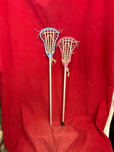Two Lacrosse sticks:  DeBeer women's lacrosse sticks. Blue 40”, Pink 37”