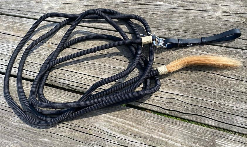 Black nylon mecate show lunge line with horsehair tassel, leather end
