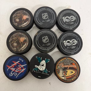 Bundle of 9 Anaheim Ducks Pucks (1 Corey Perry Autographed, 2 MVP, 4 game used, and 2 historic)